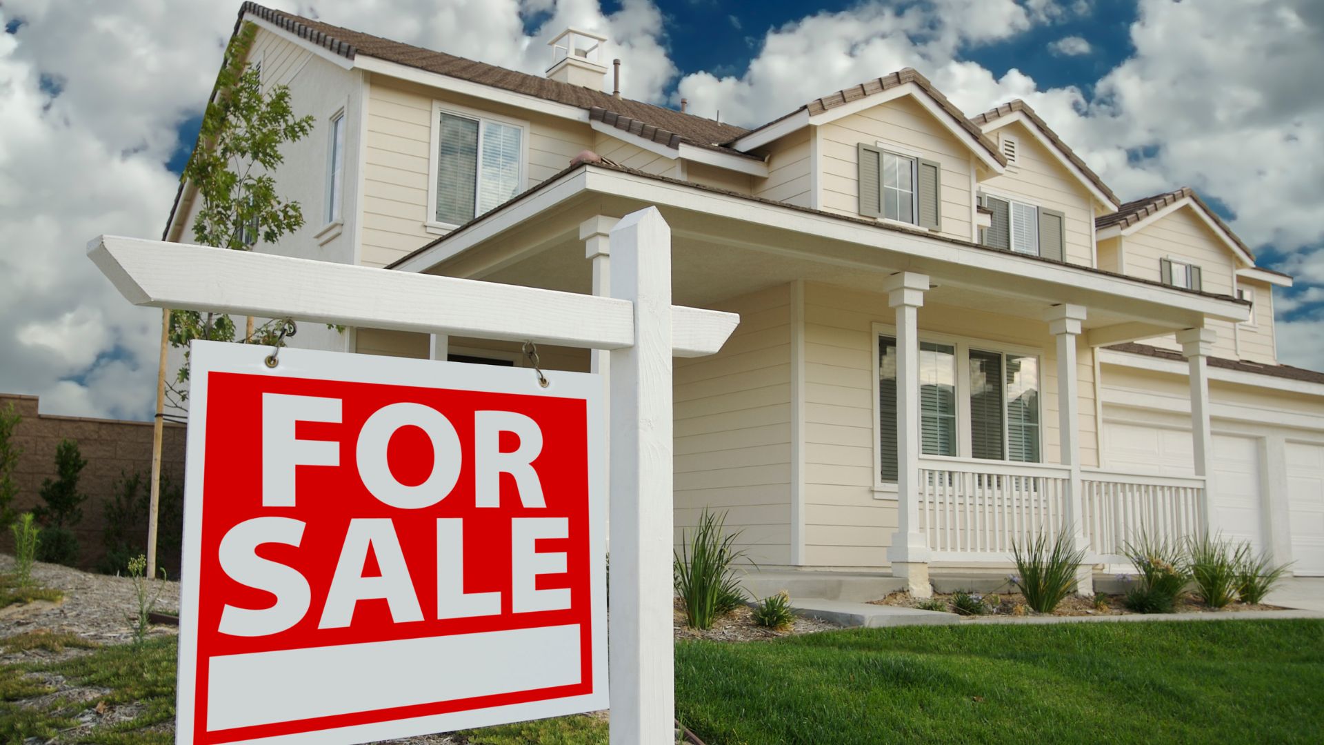 A for sale sign in front of a house