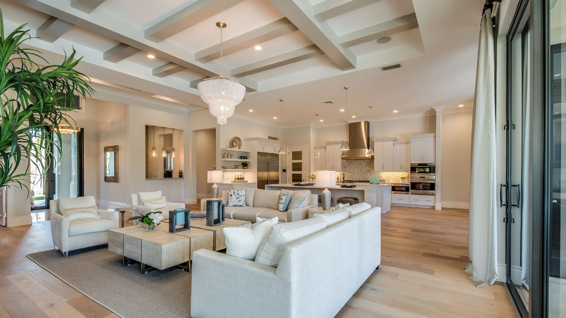 A living room filled with furniture next to a kitchen