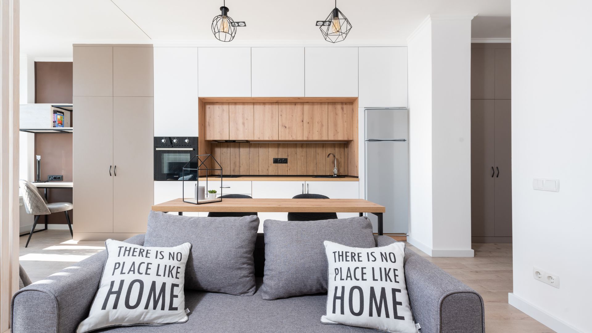 A living room filled with furniture and a kitchen