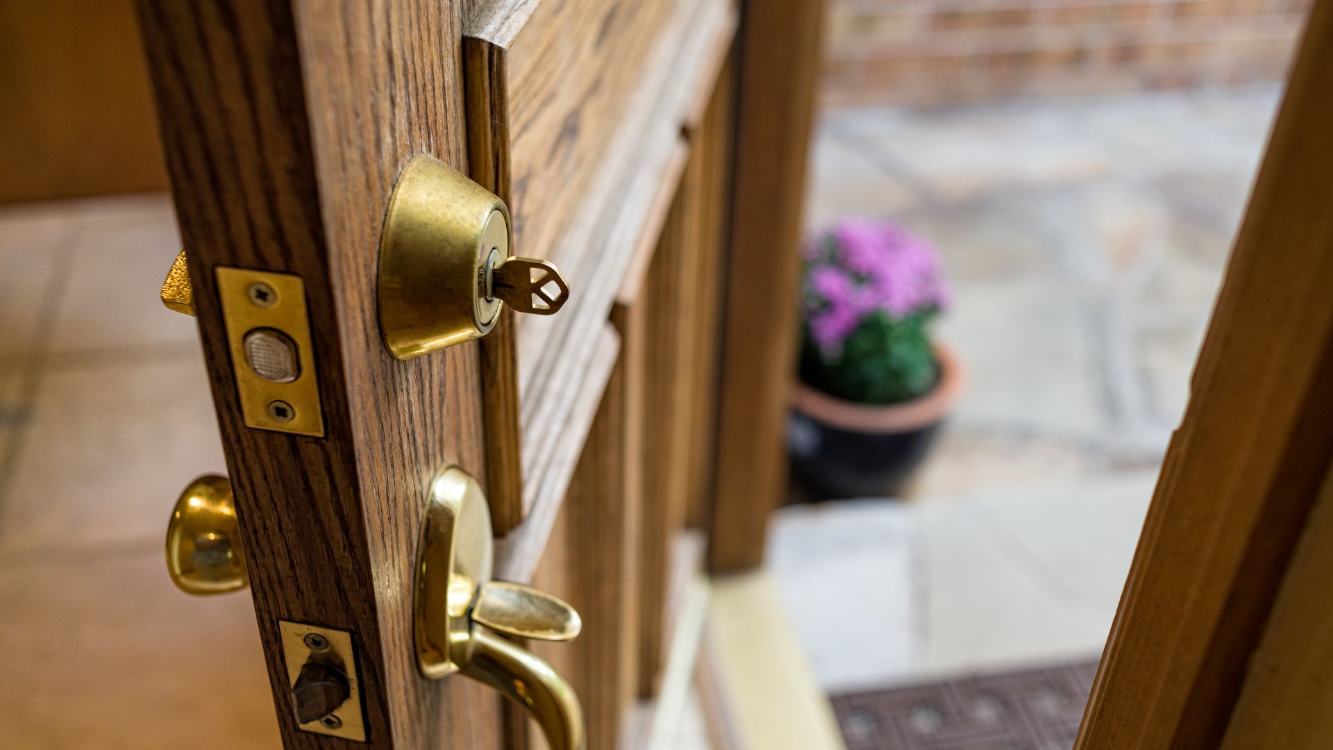 A close up of a door handle on a wooden door