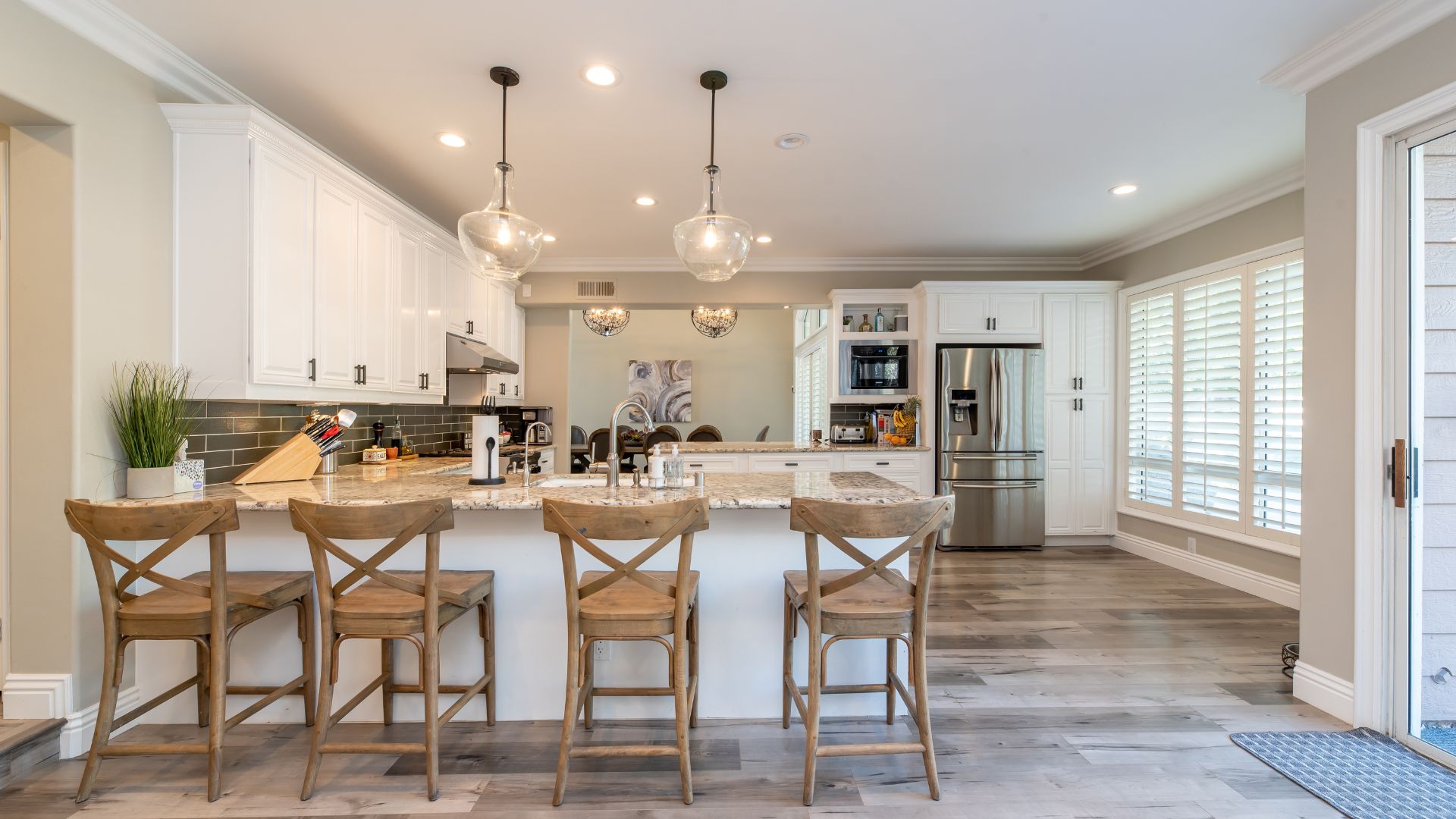 A kitchen with a center island and a breakfast bar