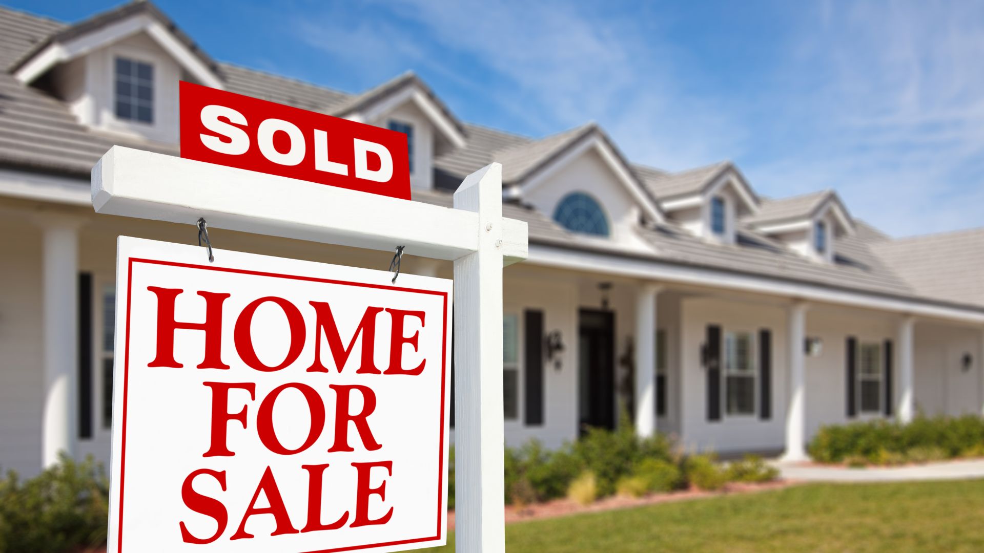 A sold home for sale sign in front of a house